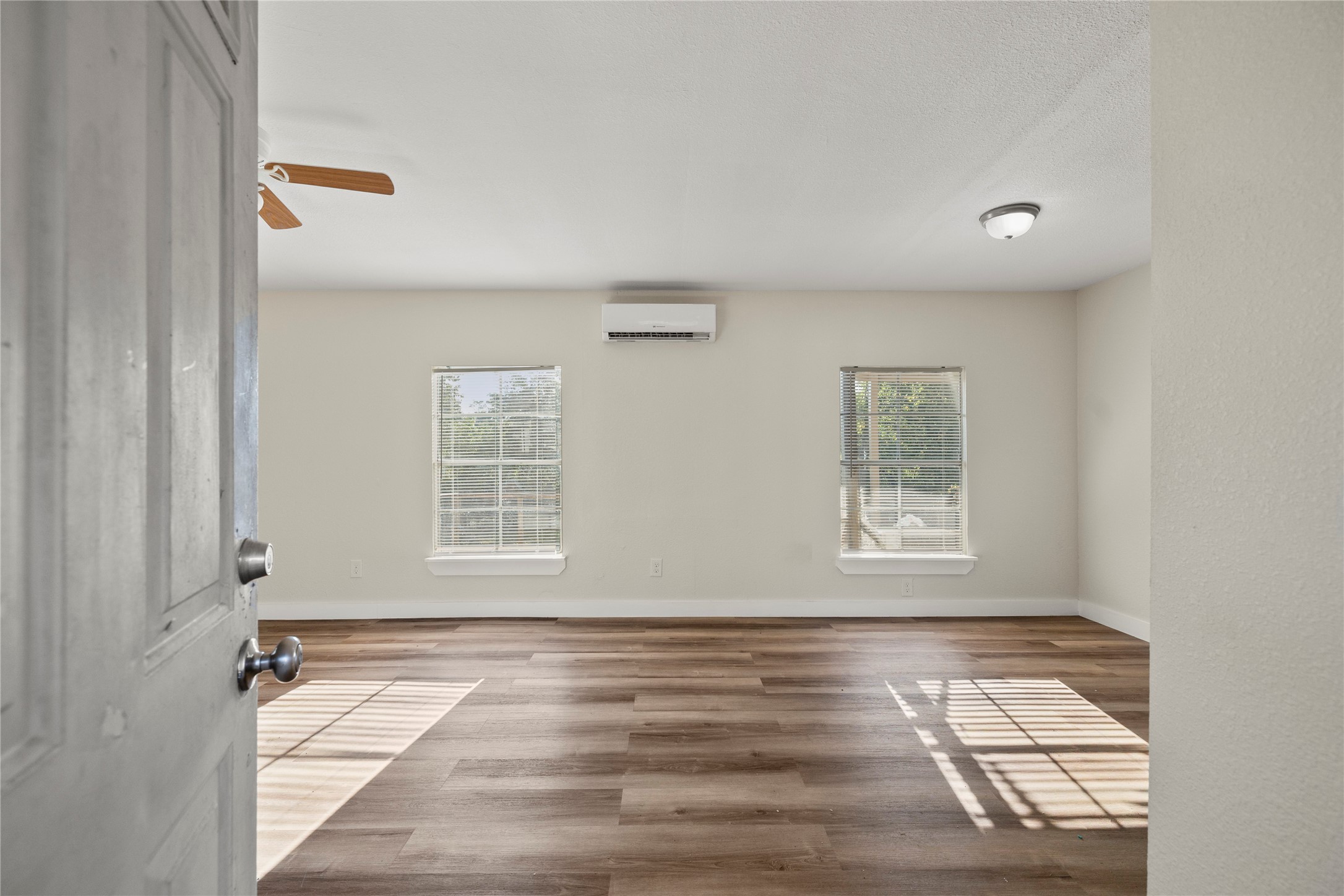 37111 Middle Trail, Unit 1 Magnolia, TX 77354 - Photo 2 of 32 a view of an empty room with wooden floor and a window