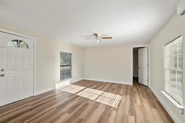 wooden floor in an empty room with a window
