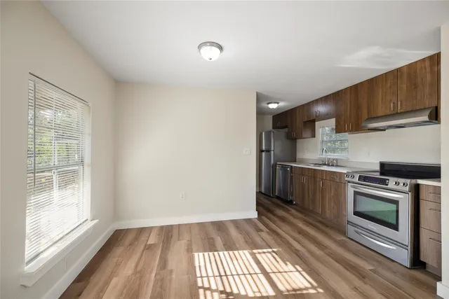 a kitchen with a sink stove and cabinets