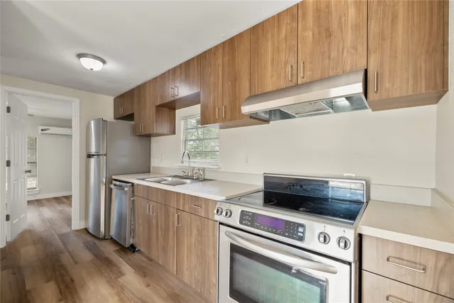a kitchen with a stove and a refrigerator