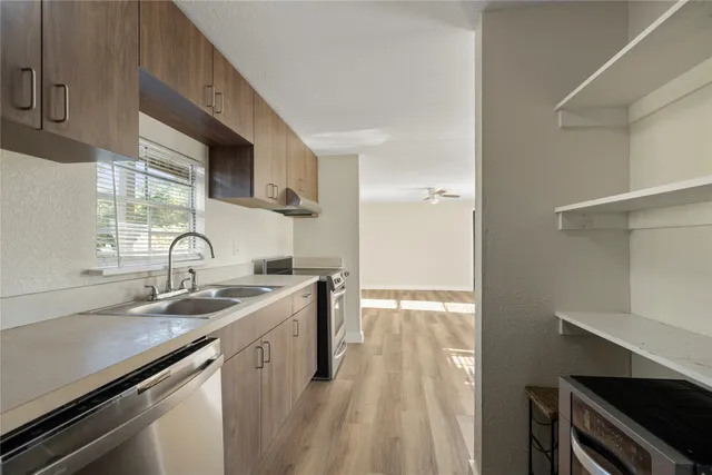a kitchen with a sink stove and cabinets