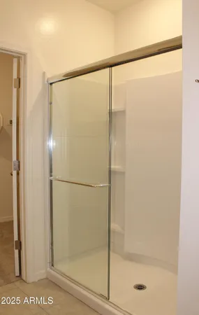 a bathroom with a glass shower door