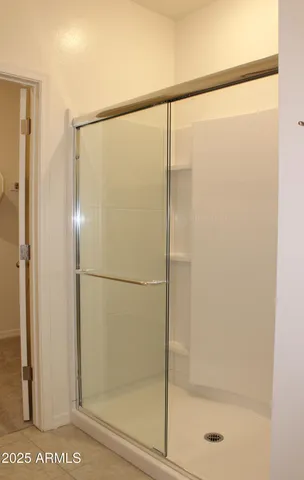 a bathroom with a glass shower door