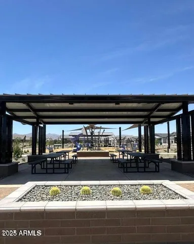 a view of a patio with a table and chairs
