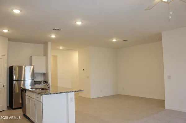 a kitchen with stainless steel appliances granite countertop a refrigerator and a stove