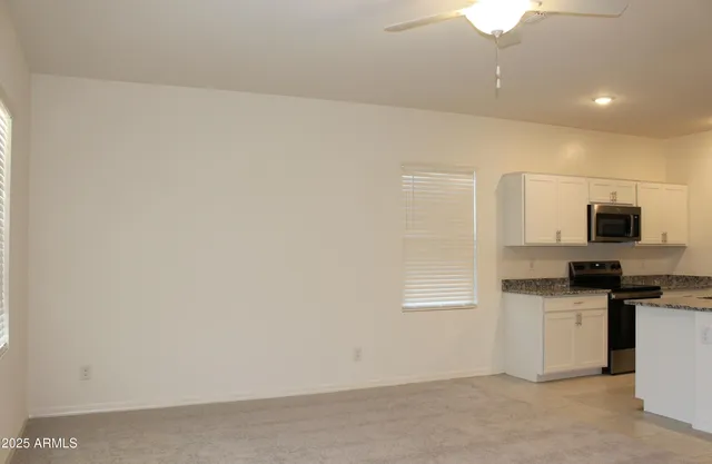 a kitchen with stainless steel appliances a refrigerator and a stove top oven