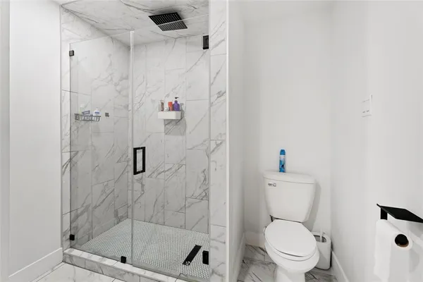 a white toilet next to a bathroom sink