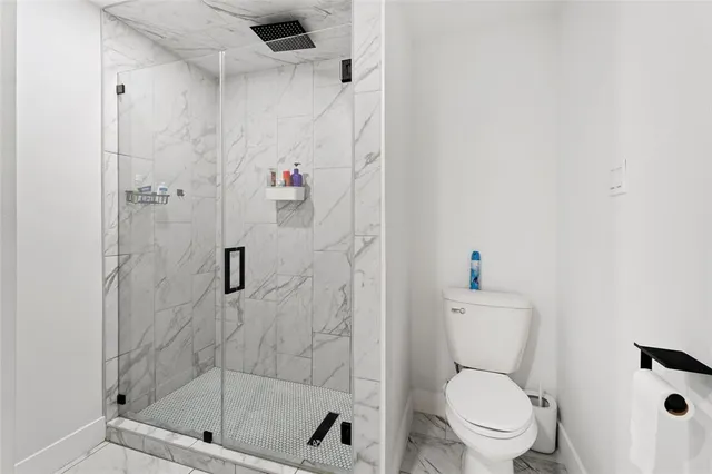 a white toilet next to a bathroom sink