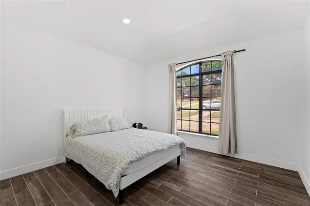 a bedroom with a bed and window