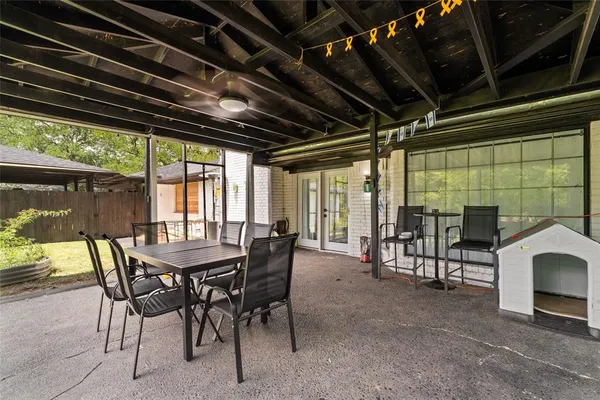 a view of a porch with furniture and a yard
