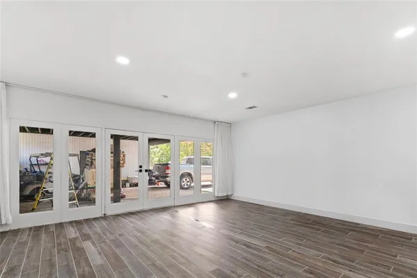 an empty room with furniture and large window