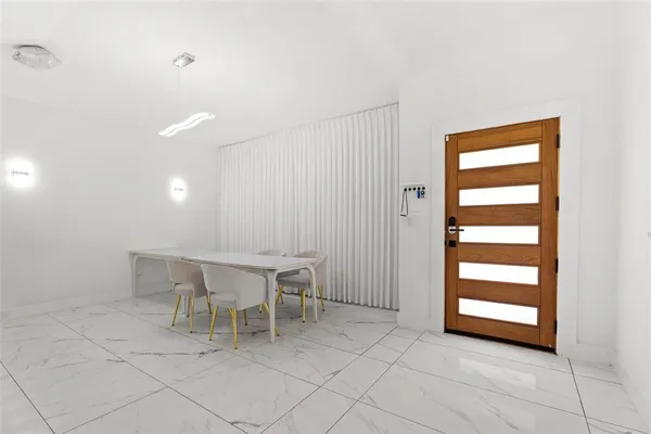 a dining room with furniture and window