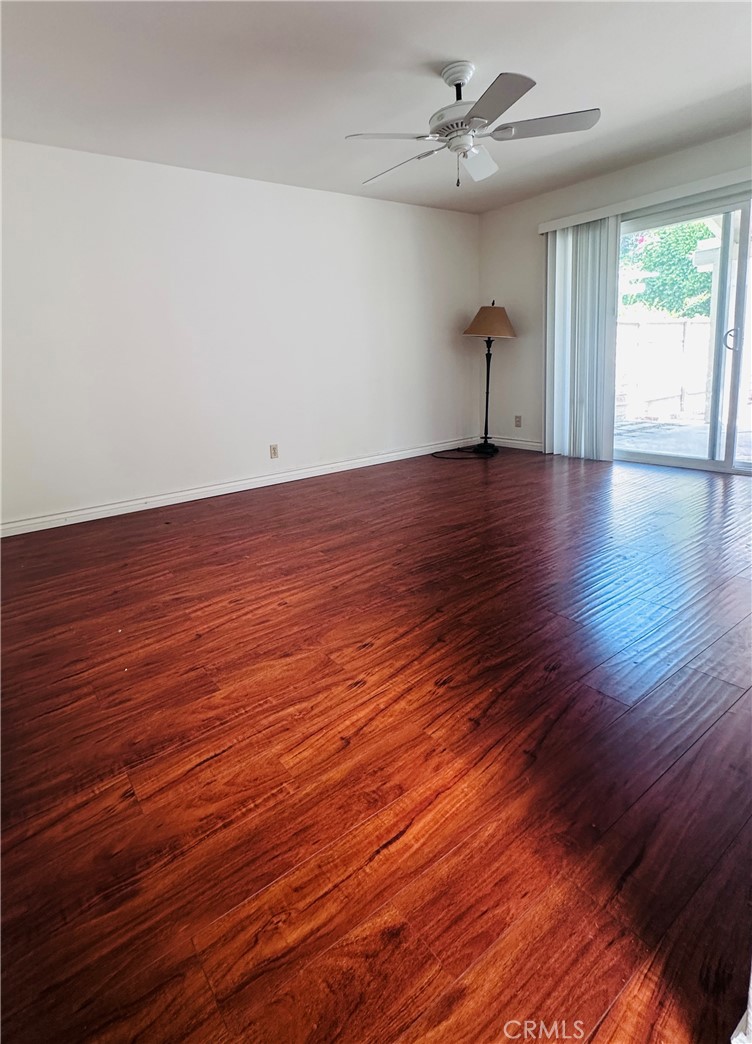 5 Glenhurst, Unit 5 Irvine, CA 92604 - Photo 5 of 16 a view of empty room with wooden floor and fan
