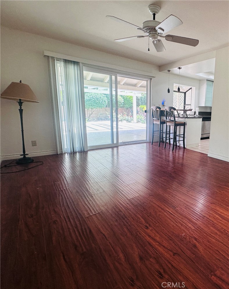 5 Glenhurst, Unit 5 Irvine, CA 92604 - Photo 6 of 16 a view of a livingroom with furniture wooden floor a ceiling fan and a window