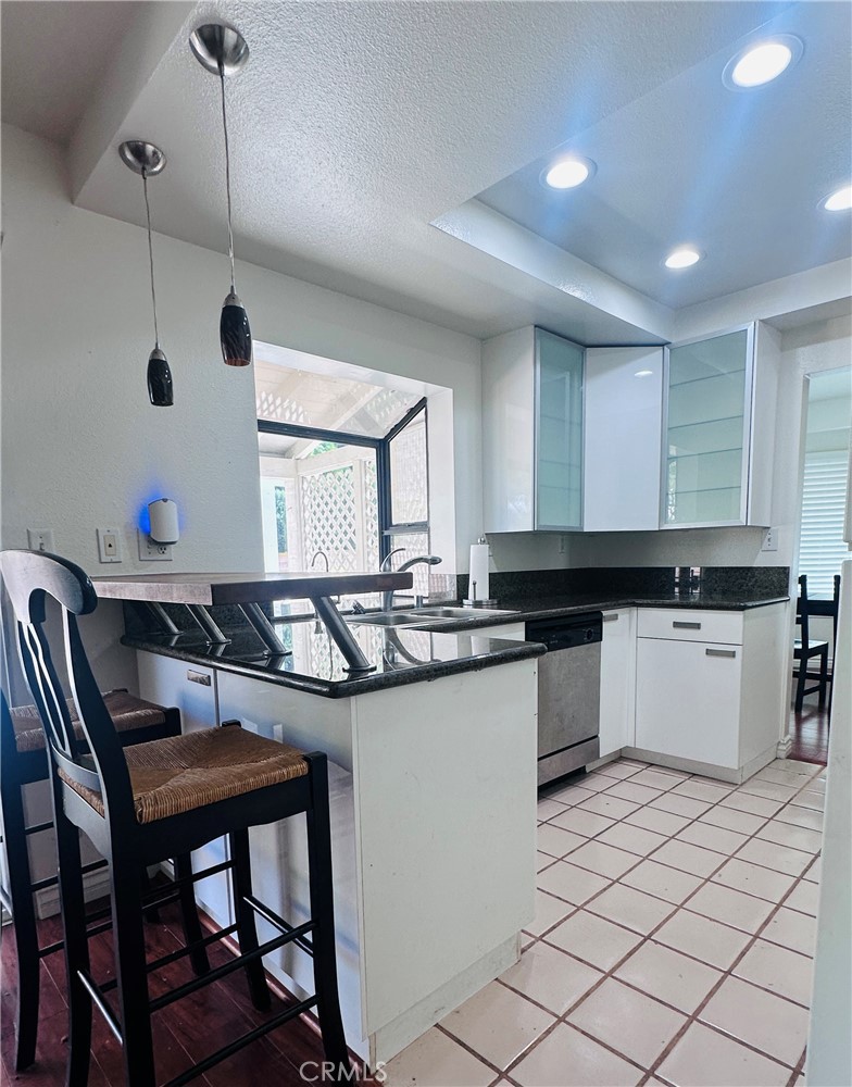 5 Glenhurst, Unit 5 Irvine, CA 92604 - Photo 9 of 16 a kitchen with a sink a counter space appliances and cabinets