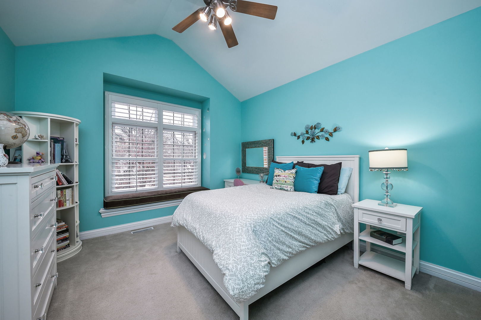 821 Wellner Road Naperville, IL 60540 - Photo 33 of 56 a bedroom with a bed and a chandelier