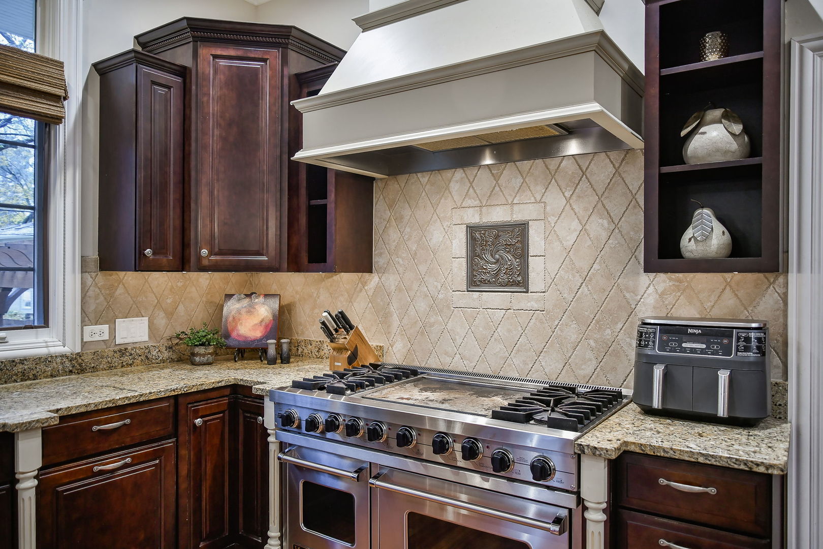 821 Wellner Road Naperville, IL 60540 - Photo 9 of 56 a kitchen with granite countertop a stove and a wooden cabinets