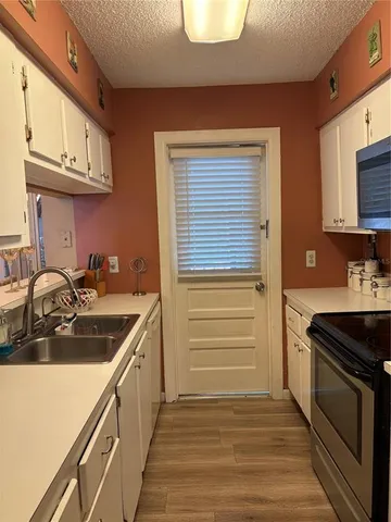 a kitchen with a sink stove and cabinets