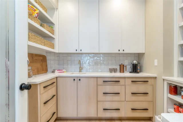 a kitchen with stainless steel appliances cabinets and a window