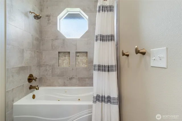 a bathroom with a bathtub and a shower