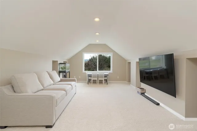 a living room with furniture a flat screen tv and a large window