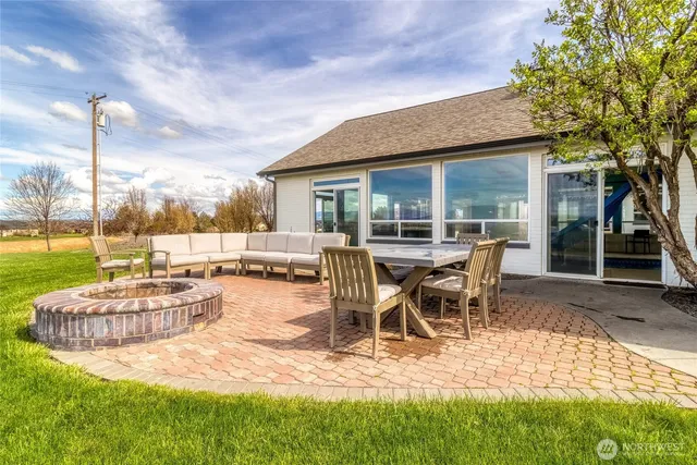 a view of a patio with table and chairs near a yard