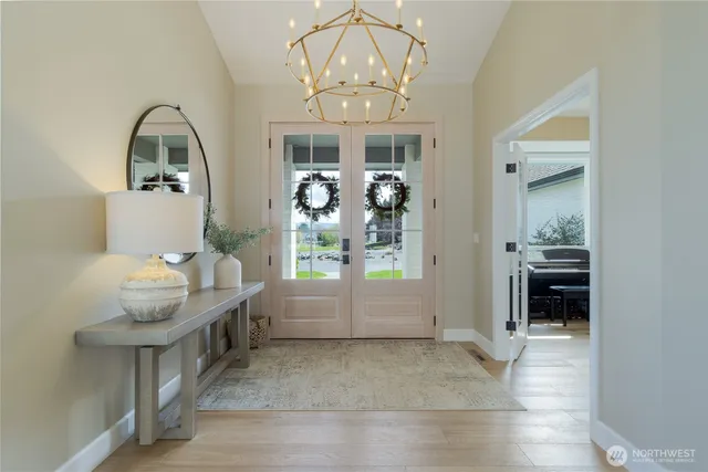 a living room with furniture and a chandelier