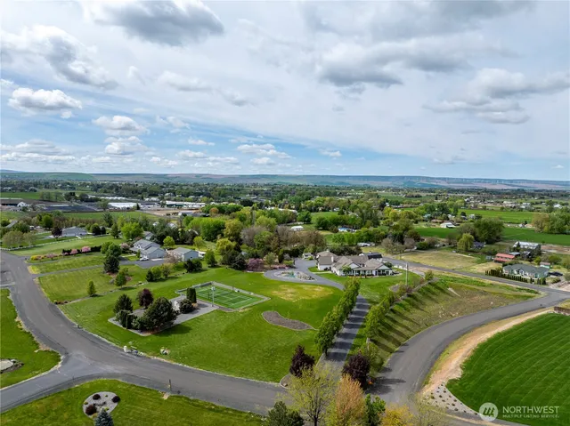 an aerial view of a house with swimming pool garden and patio