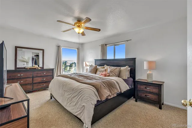 a bedroom with a bed and a chandelier