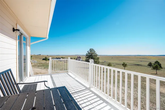 a view of a balcony with wooden floor