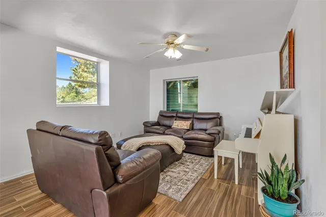 a living room with furniture and a chandelier