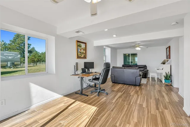 a en suite bathroom with a granite countertop sink toilet and mirror