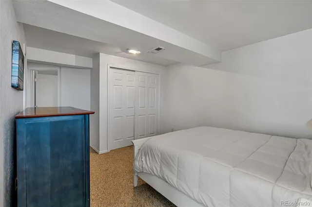 a bedroom with a bed and a table in it