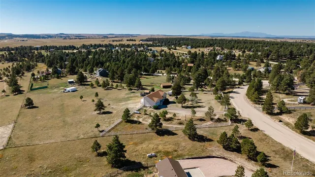 an aerial view of a house with outdoor space