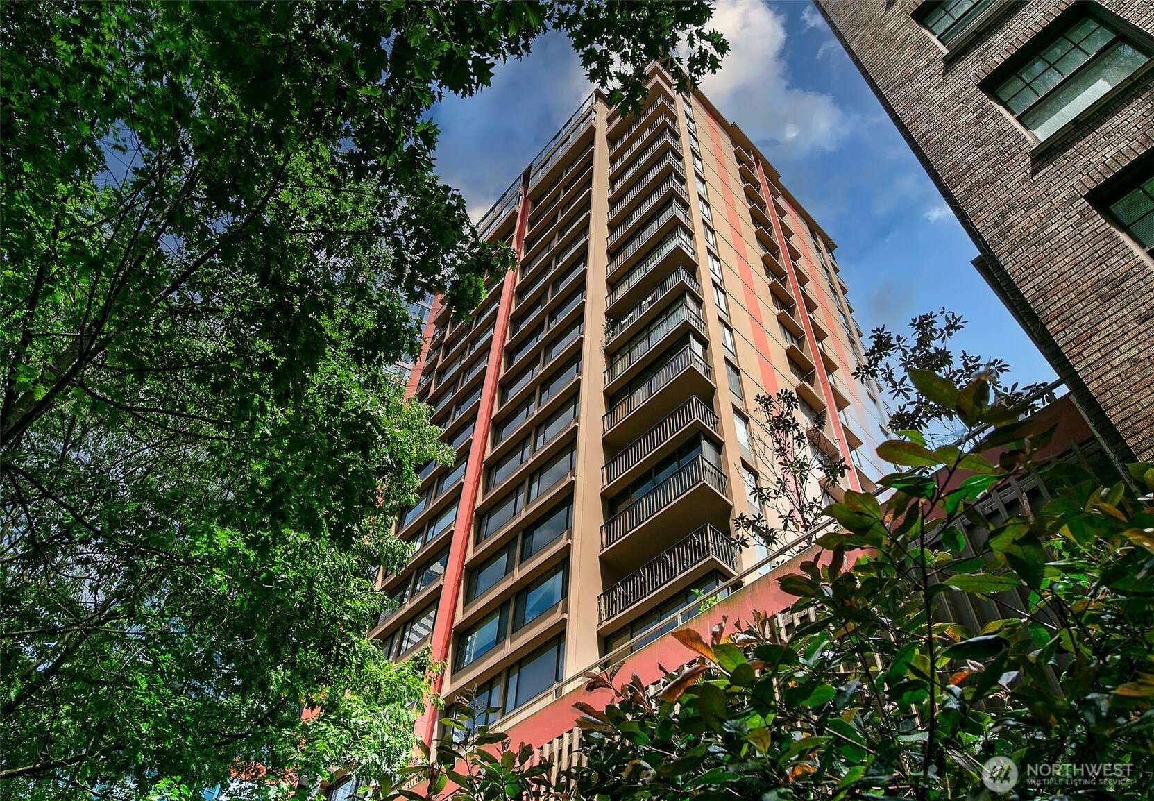 an aerial view of multi story residential apartment building with plants