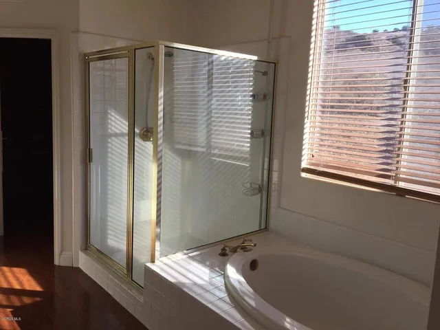 a bathroom with a bathtub and a shower