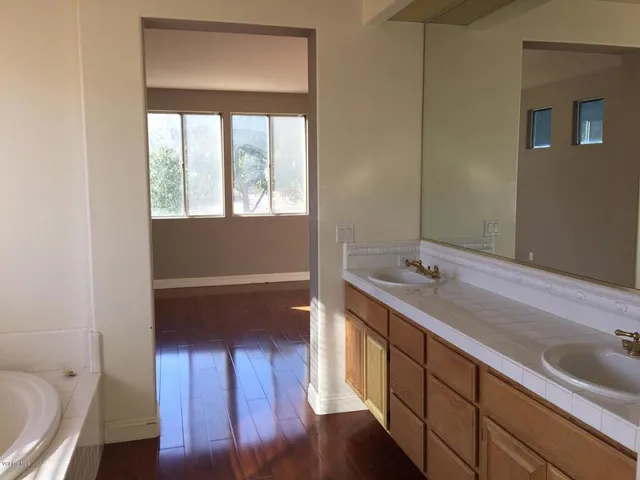 a bathroom with a sink a toilet and a window