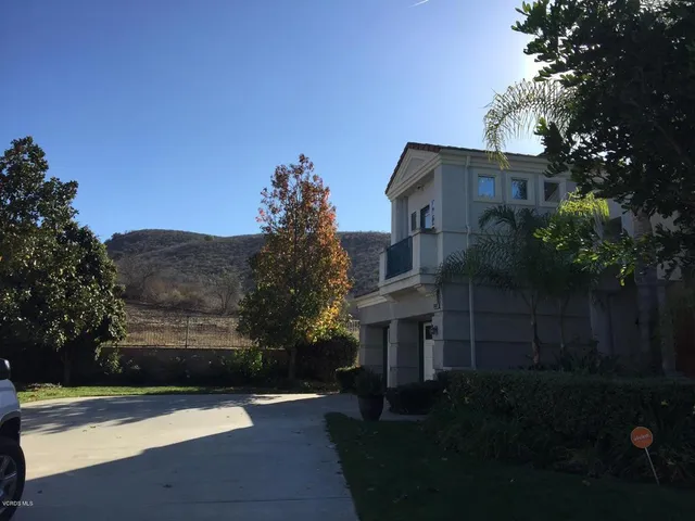 a front view of a house with plants