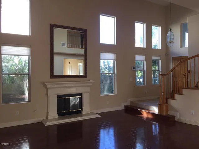 a living room with wooden floors and a fireplace