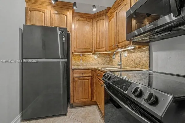 a kitchen with a refrigerator and a sink