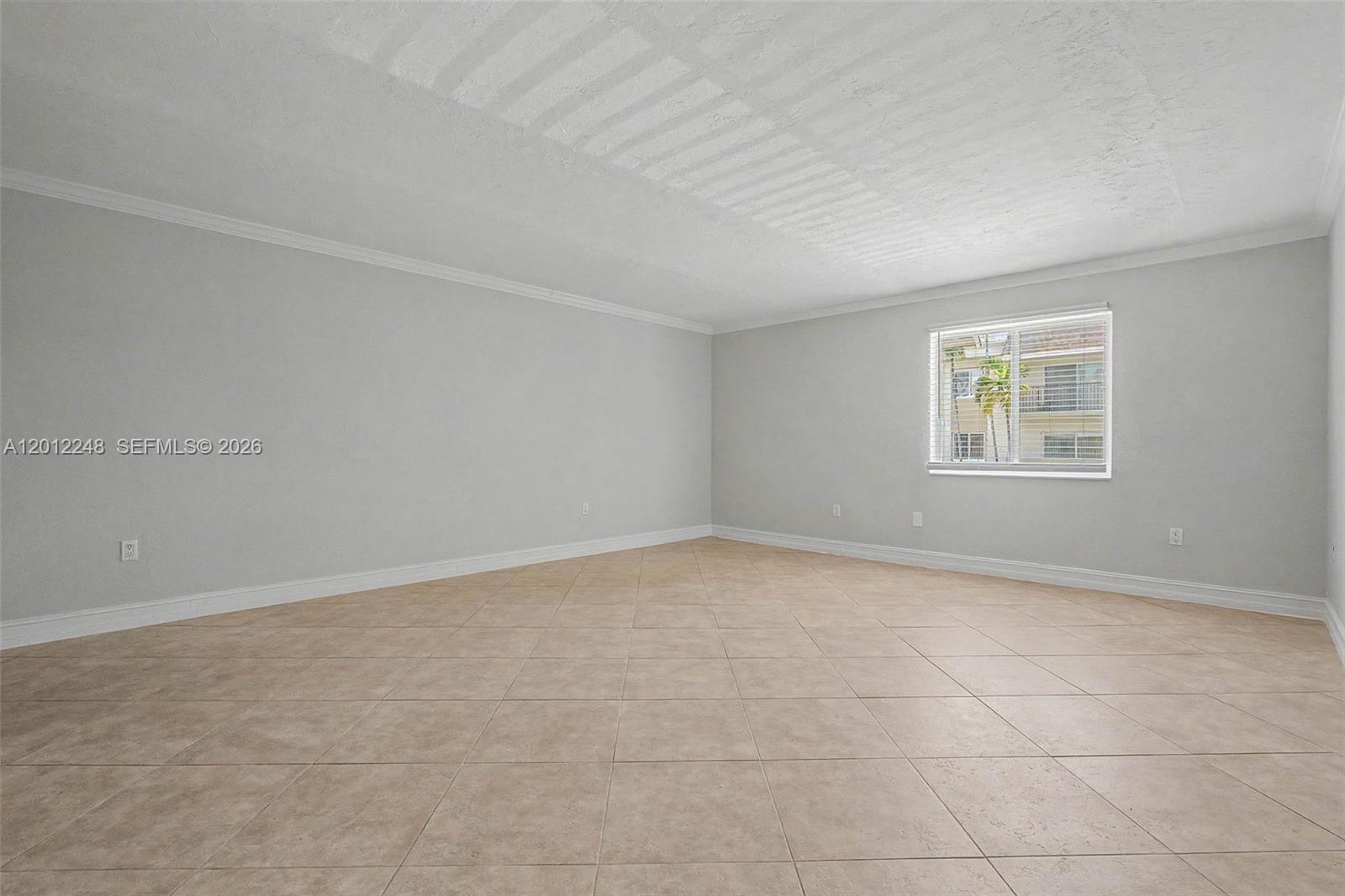 8609 Southwest 68th Court, Unit 22 Pinecrest, FL 33156 - Photo 4 of 15 an empty room with a window
