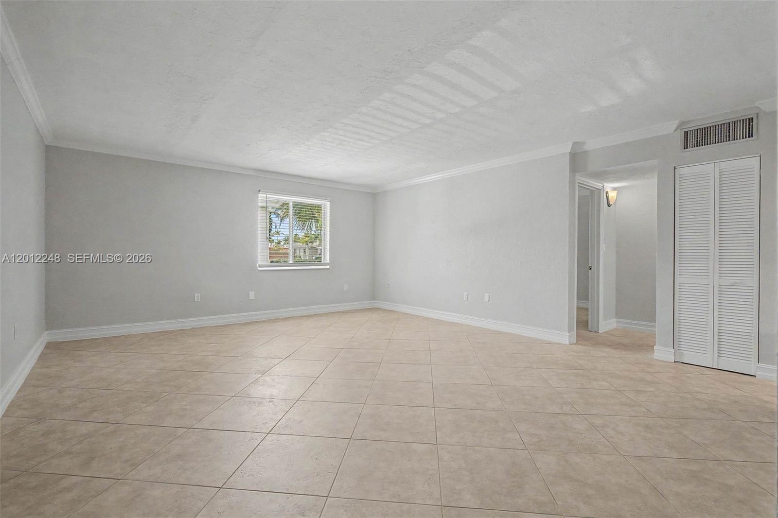8609 Southwest 68th Court, Unit 22 Pinecrest, FL 33156 - Photo 5 of 15 a view of an empty room with a window