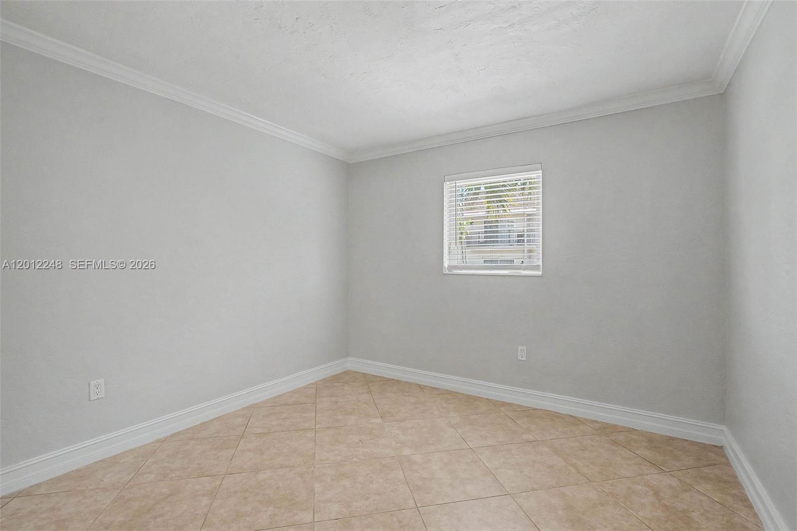 8609 Southwest 68th Court, Unit 22 Pinecrest, FL 33156 - Photo 8 of 15 an empty room with a window