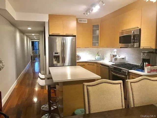 a kitchen with a sink appliances and cabinets