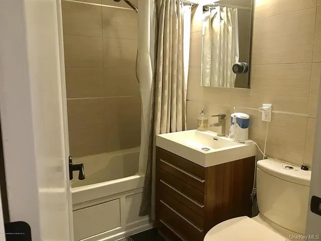 a bathroom with a sink toilet and tub