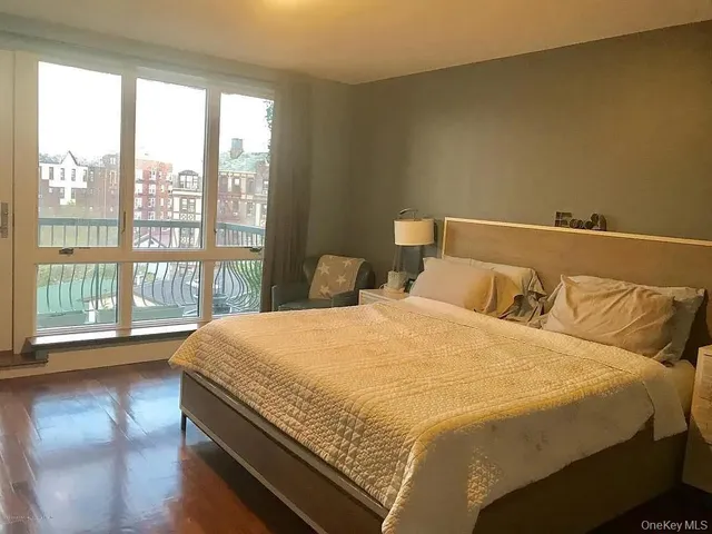 a bedroom with a large bed and a large window