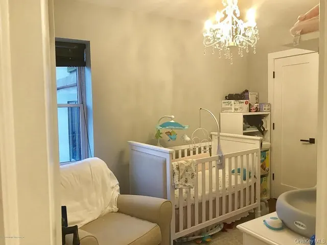 a view of a bedroom with furniture and chandelier