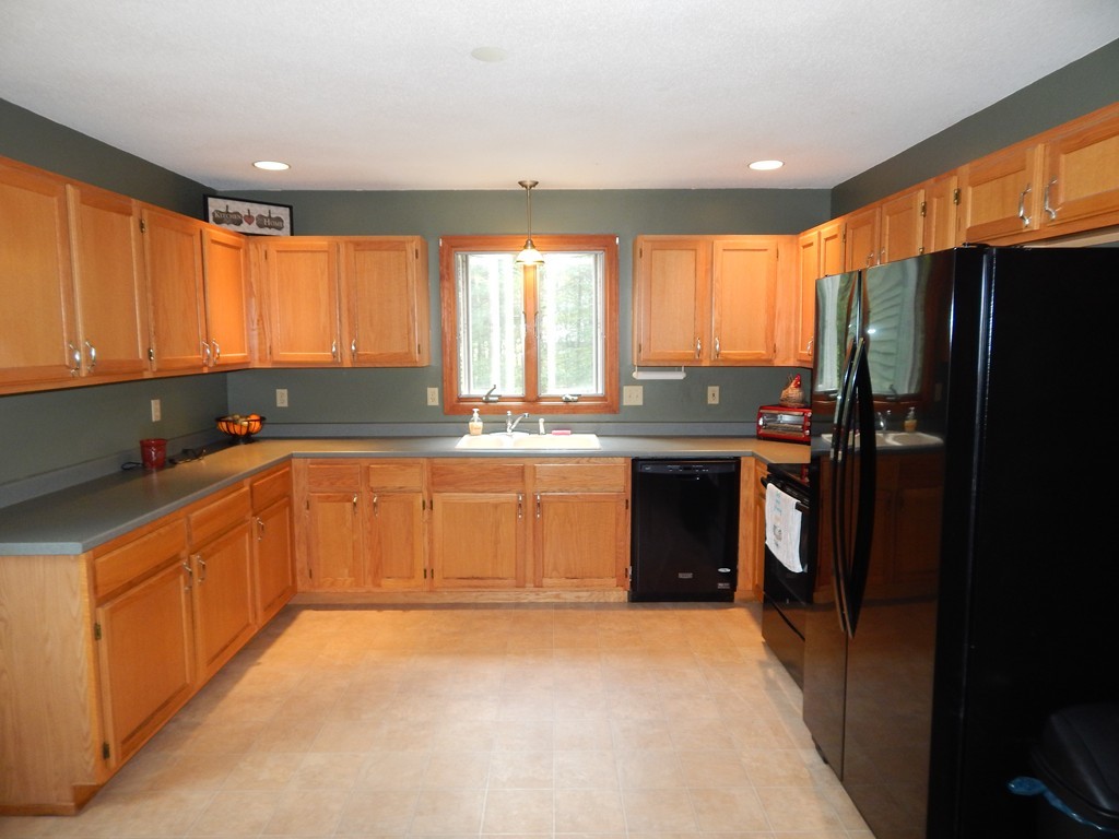 129 Boston Road Palmer, MA 01069 - Photo 6 of 23 a kitchen with stainless steel appliances granite countertop a refrigerator a sink a stove a counter space and cabinets