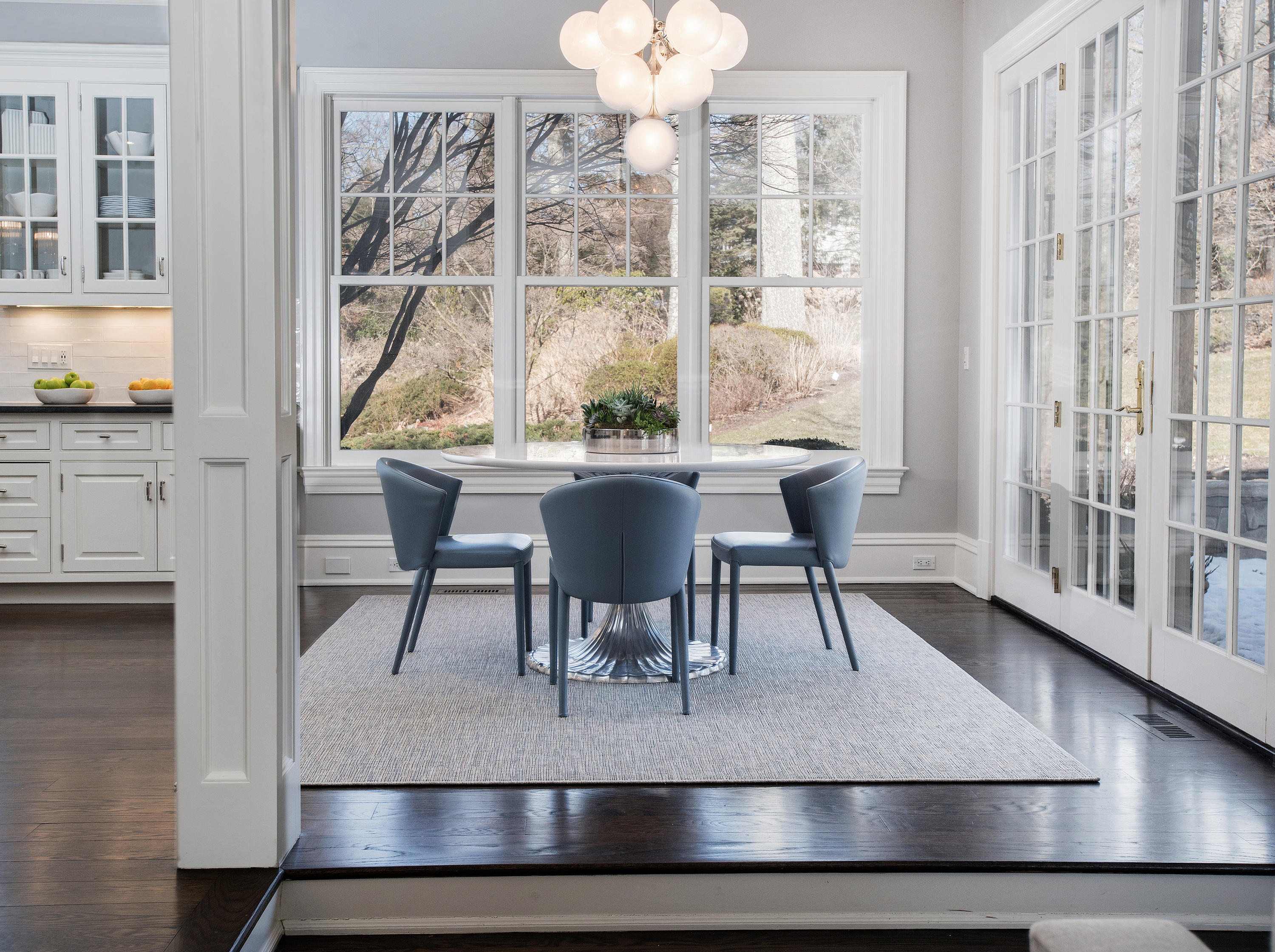 1629 Ponus Ridge Road New Canaan, CT 06840 - Photo 22 of 51 a view of a dining room with furniture a chandelier and wooden floor