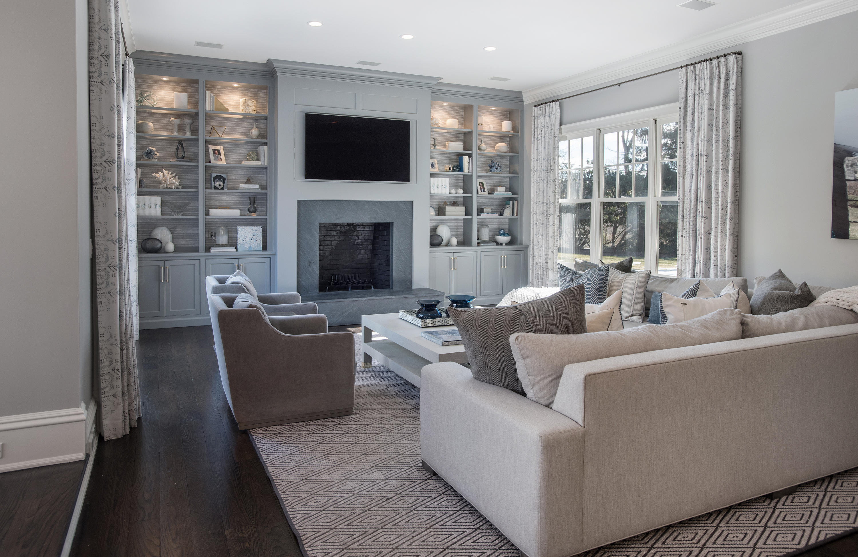 1629 Ponus Ridge Road New Canaan, CT 06840 - Photo 24 of 51 a living room with furniture a flat screen tv and a fireplace